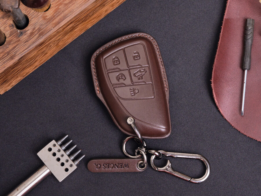 Leather GMC Sierra key fob cover with metal keyring and leather tag displayed on dark background