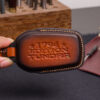 Leather Toyota Tundra key fob cover with embossed Tundra logo held in hand showing stitched edges
