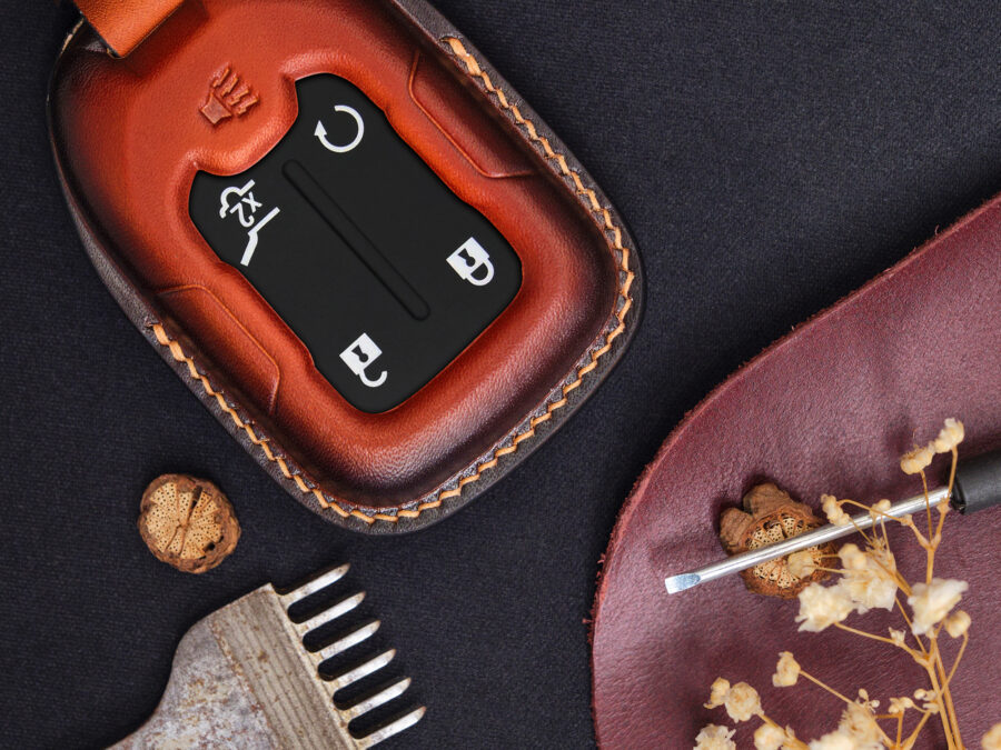 Leather GMC Terrain key fob cover close-up showing button layout and stitched edges