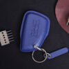 Blue leather GMC Yukon key fob cover with embossed GMC logo and metal keyring