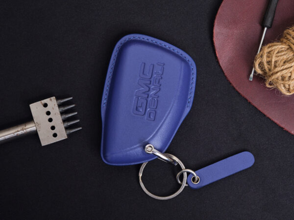 Blue leather GMC Yukon key fob cover with embossed GMC logo and metal keyring